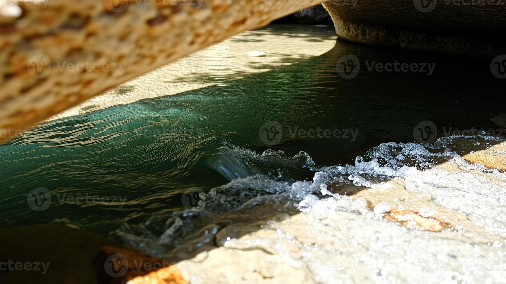 Water Flowing Under a Rock Archway photo