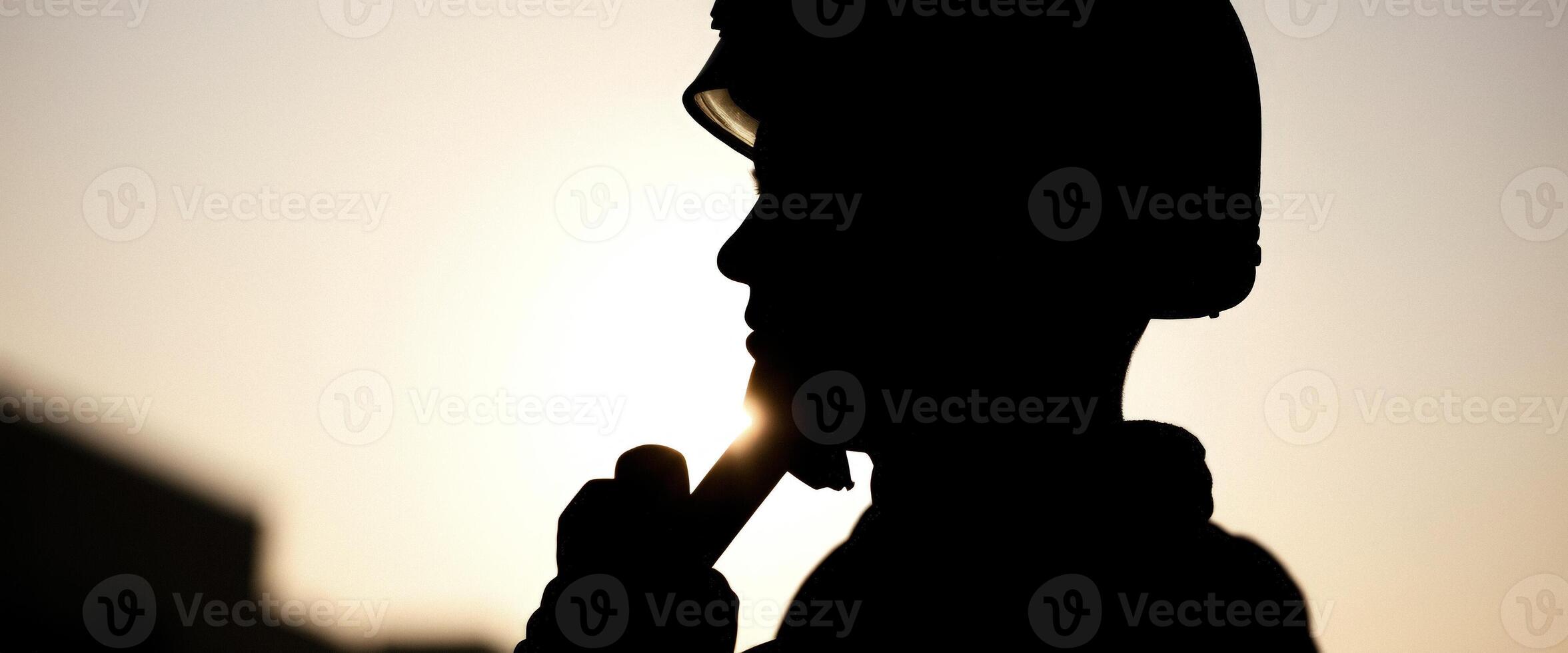 Silhouette of a Person in a Helmet Against the Sunset photo