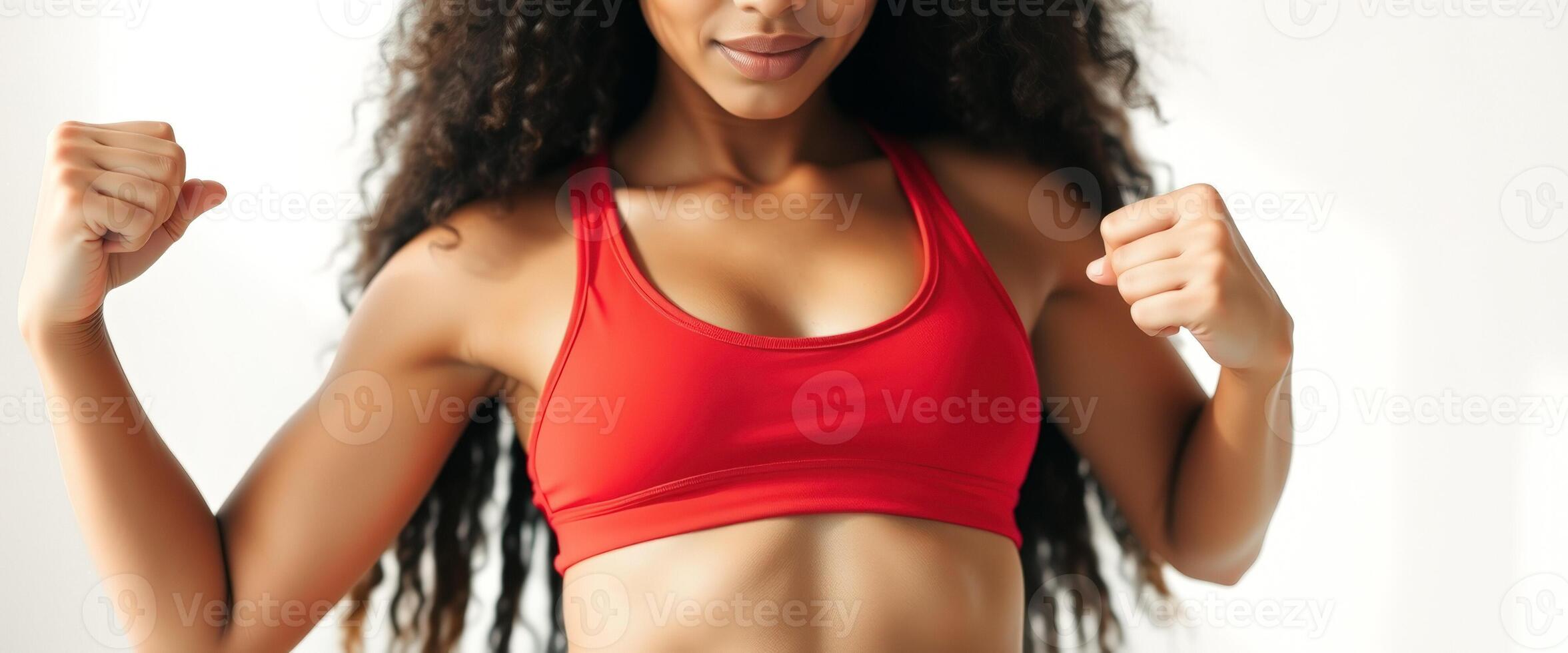 Close-up of a woman's arms and chest in a red sports bra photo