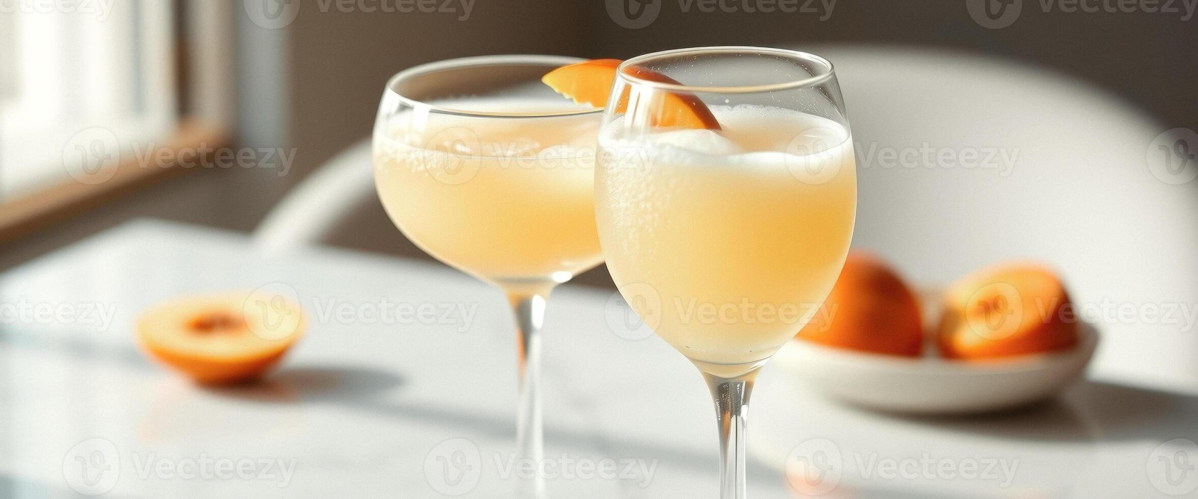 Two glasses of peach cocktail with fresh peach slices photo
