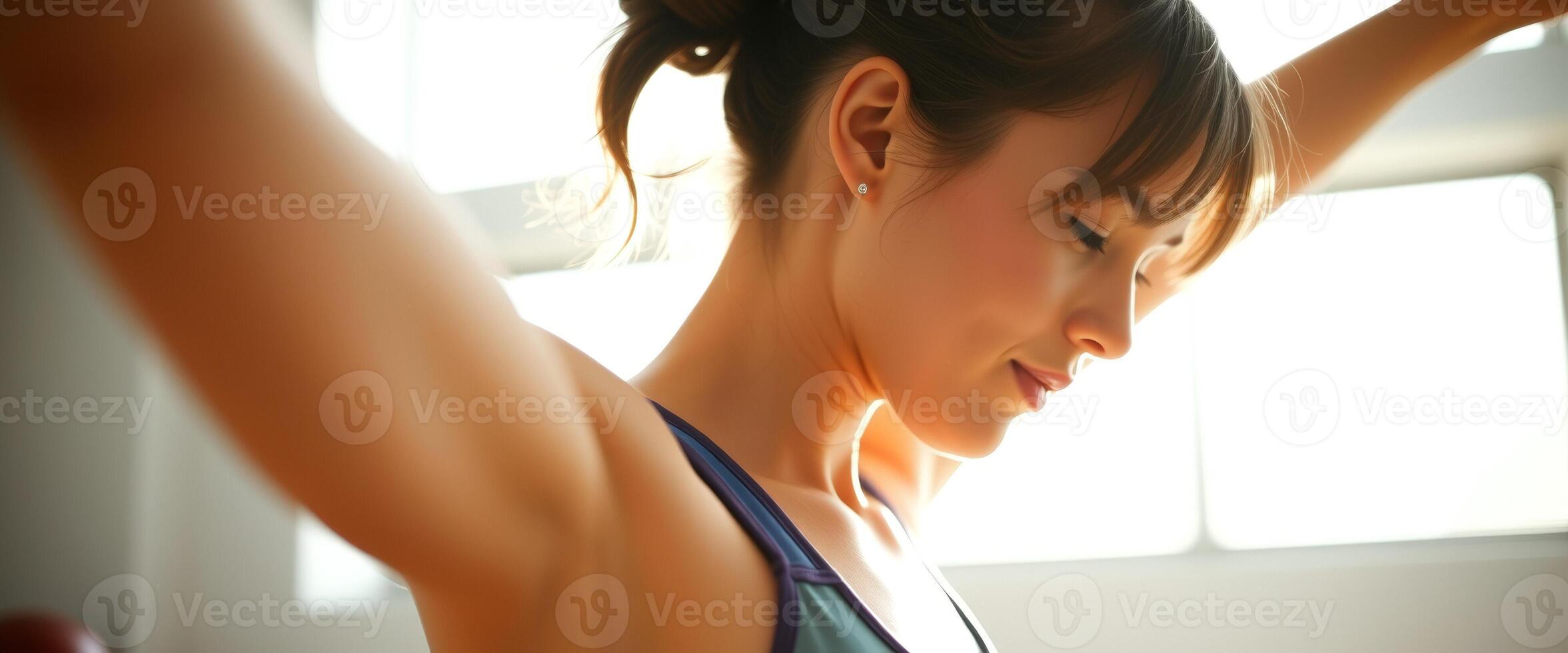 Young Woman Stretching in the Light photo