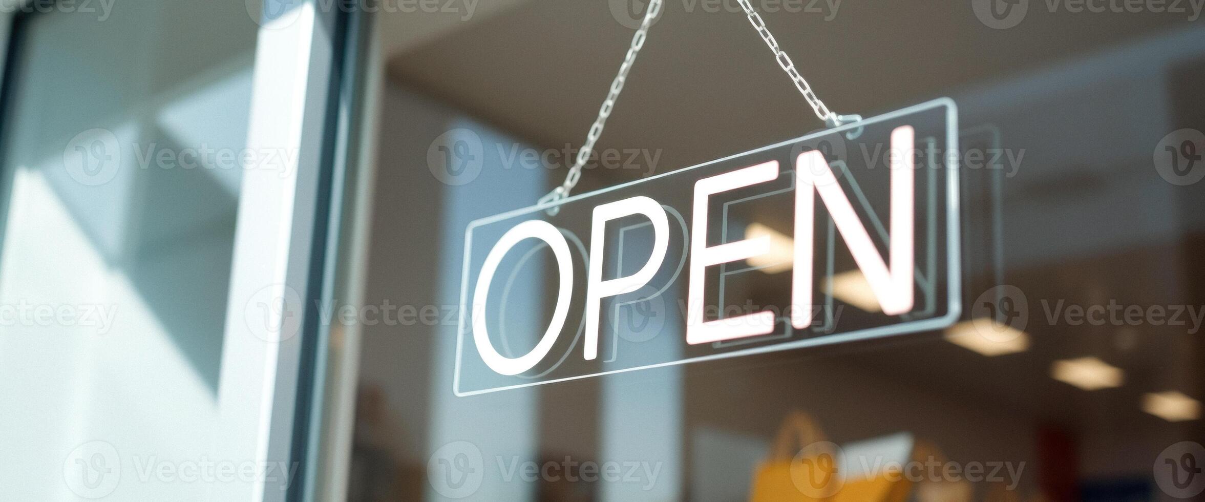 Open sign hanging on a glass door photo