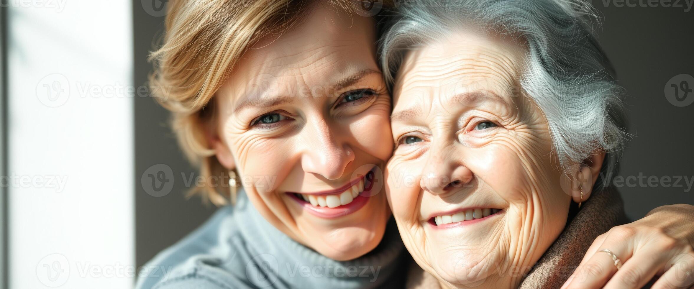 Portrait of a young woman embracing her elderly mother photo