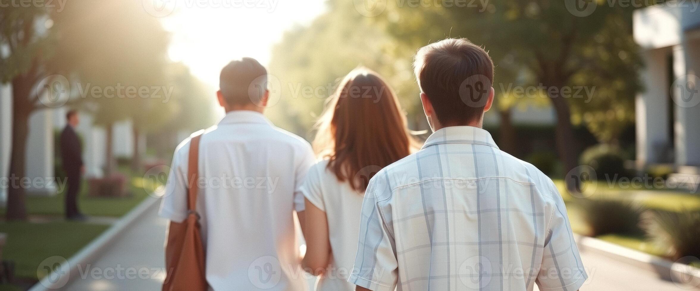 Family Walking Away From The Camera In A Sunny Day photo