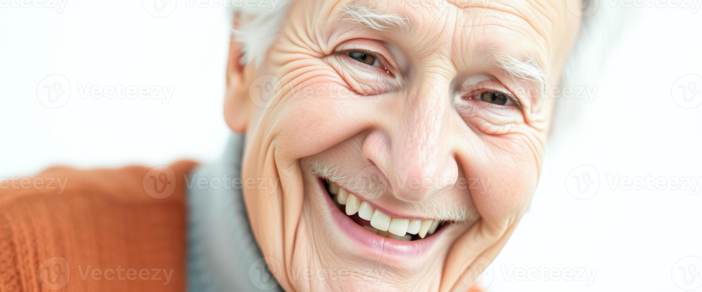 Close-up of a smiling senior man with white hair photo