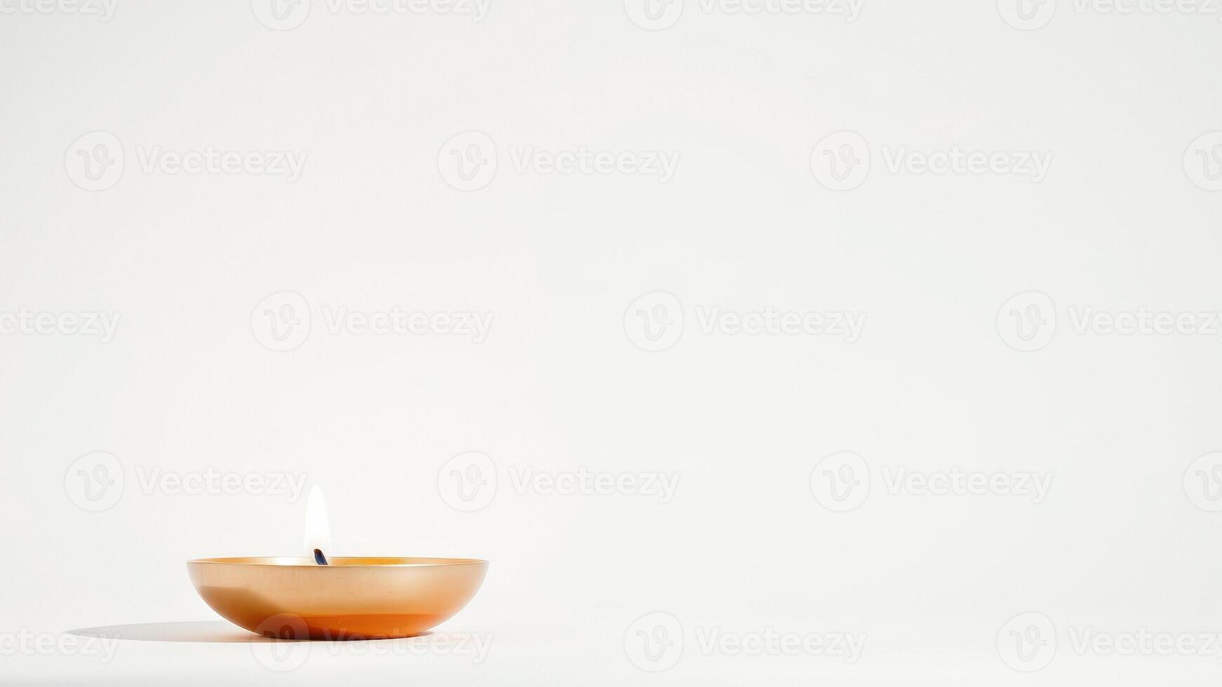 Single burning candle on a white background photo