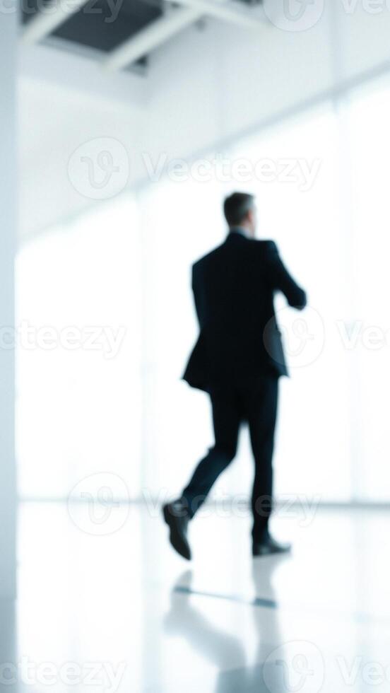 Blurred Silhouette of a Man Walking in an Office photo
