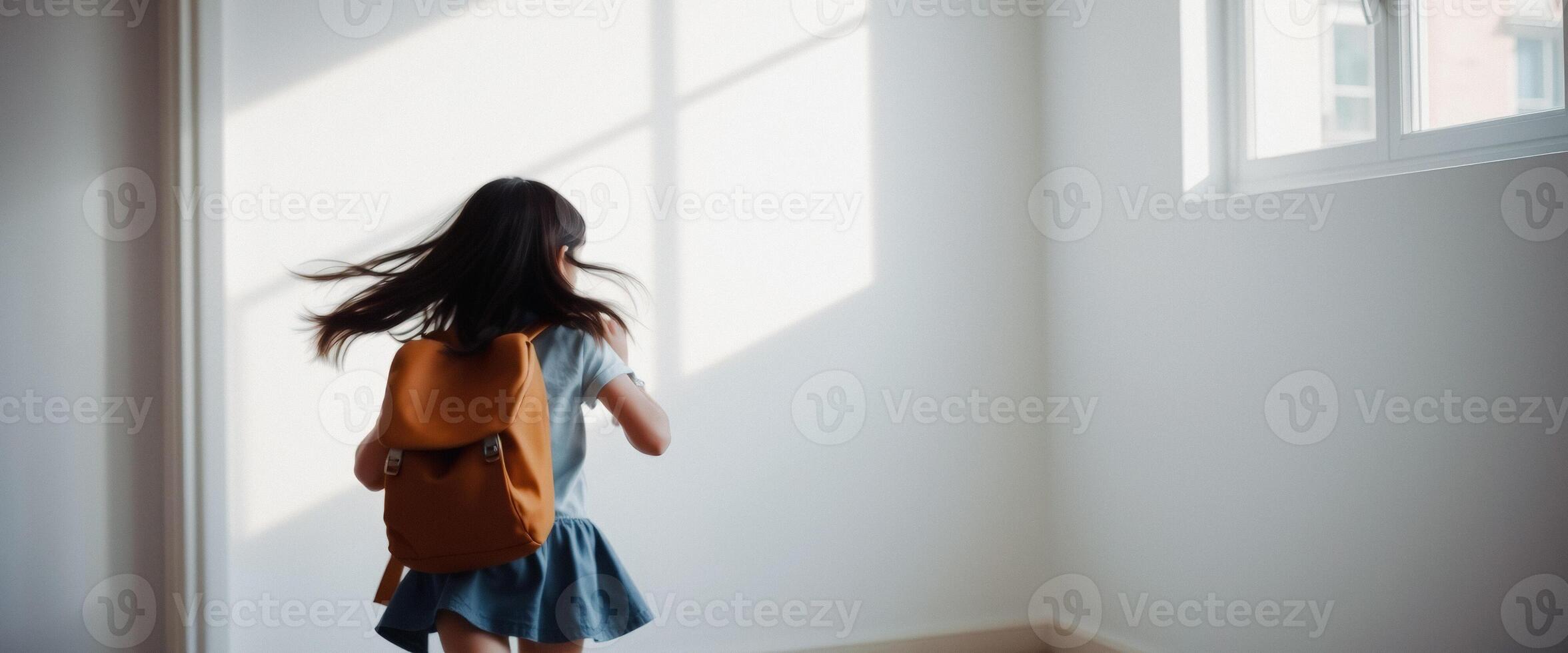 Young girl with backpack walks towards the light photo