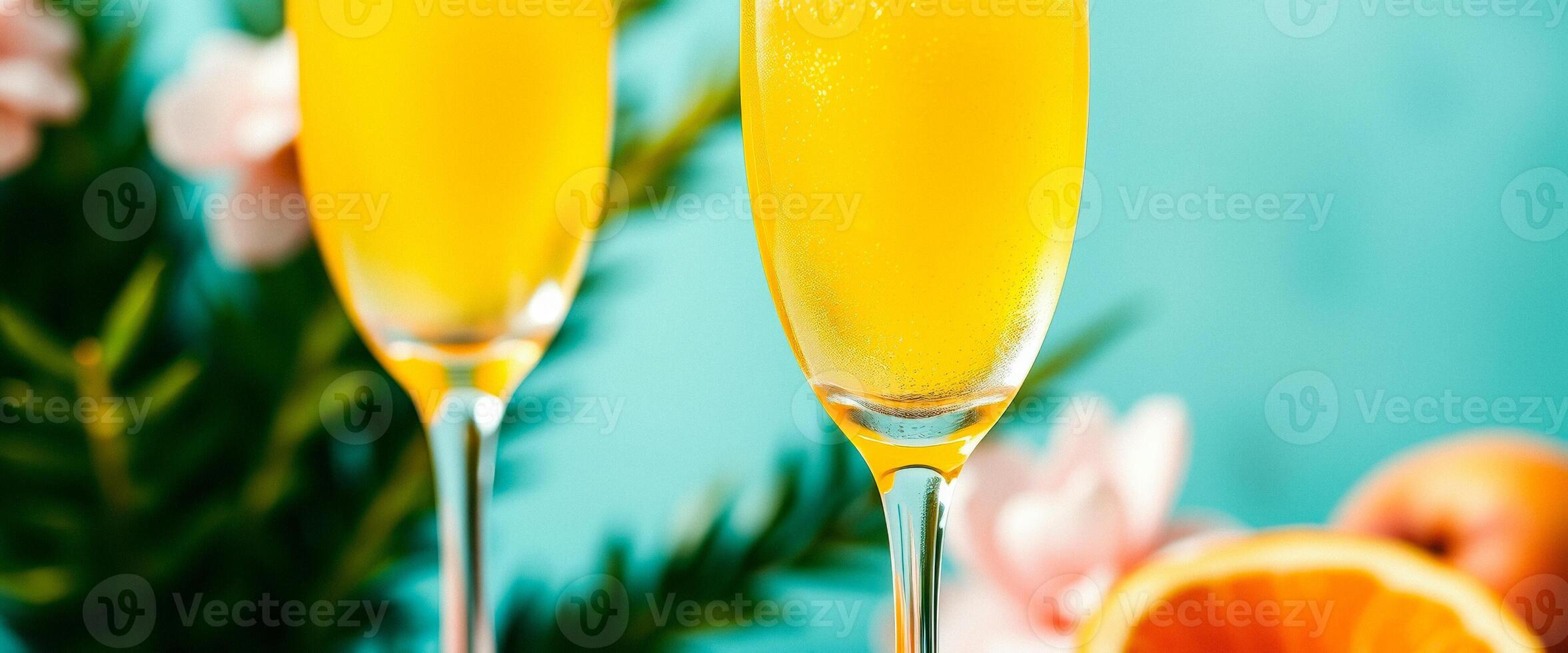 Two Glasses of Mimosa with Orange Slices and Flowers photo