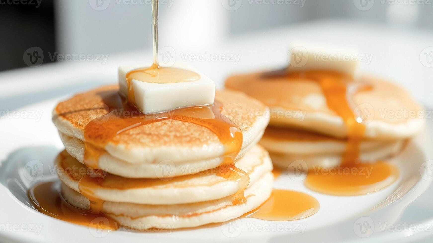 Close up of a stack of pancakes with syrup and butter photo