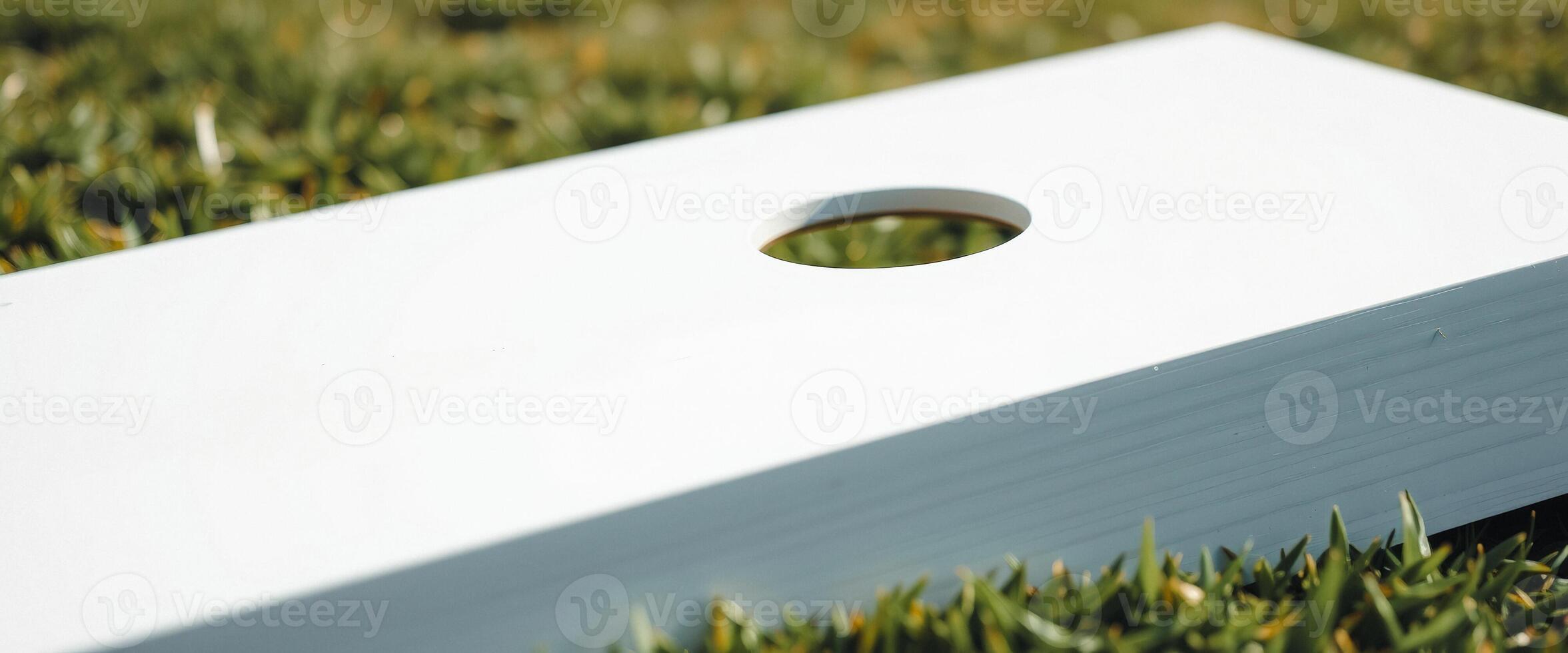 White Cornhole Board with Grass Background photo