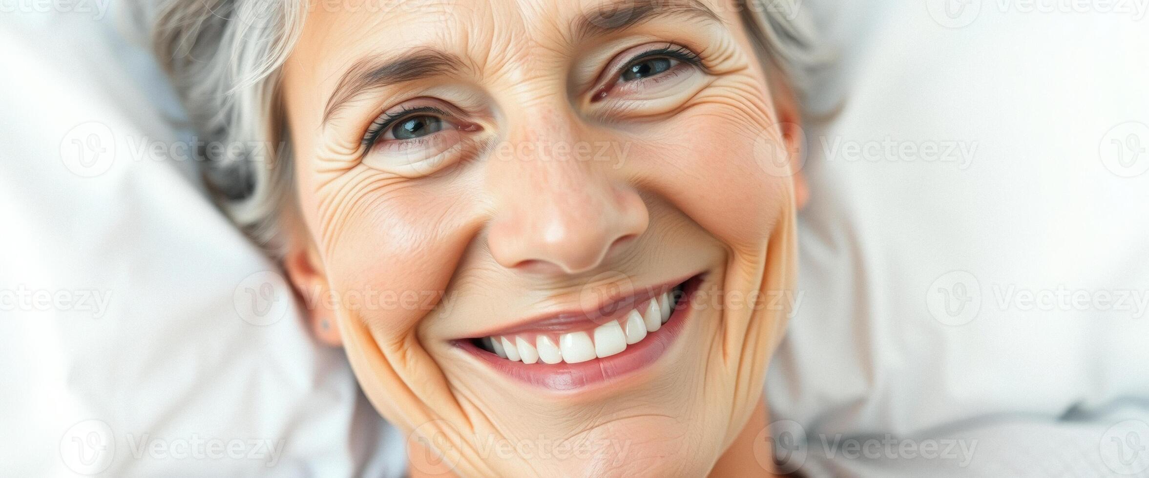 Happy Senior Woman Smiling in Bed photo