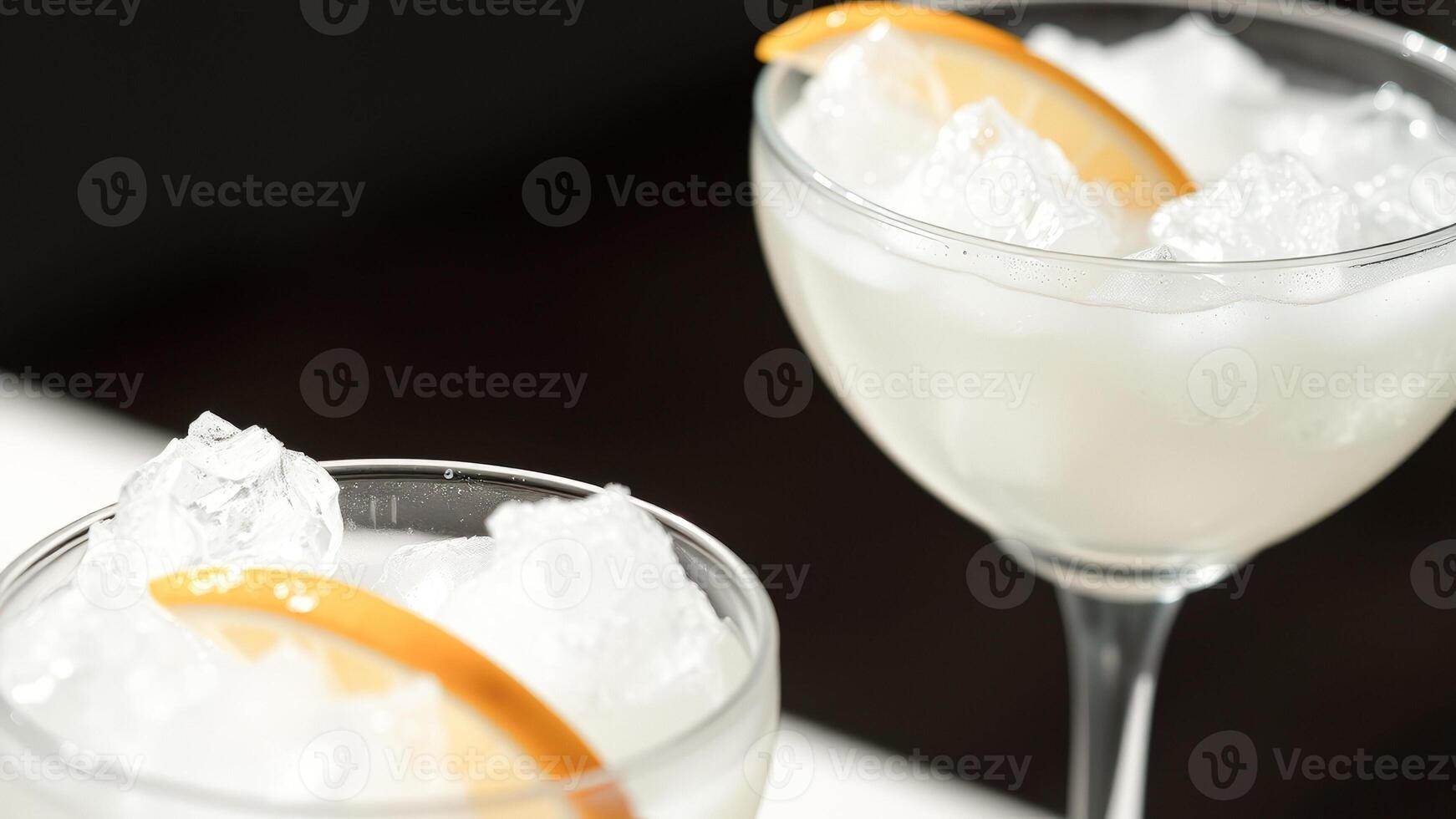 Closeup of two glasses of refreshing drinks with ice and lemon slices photo