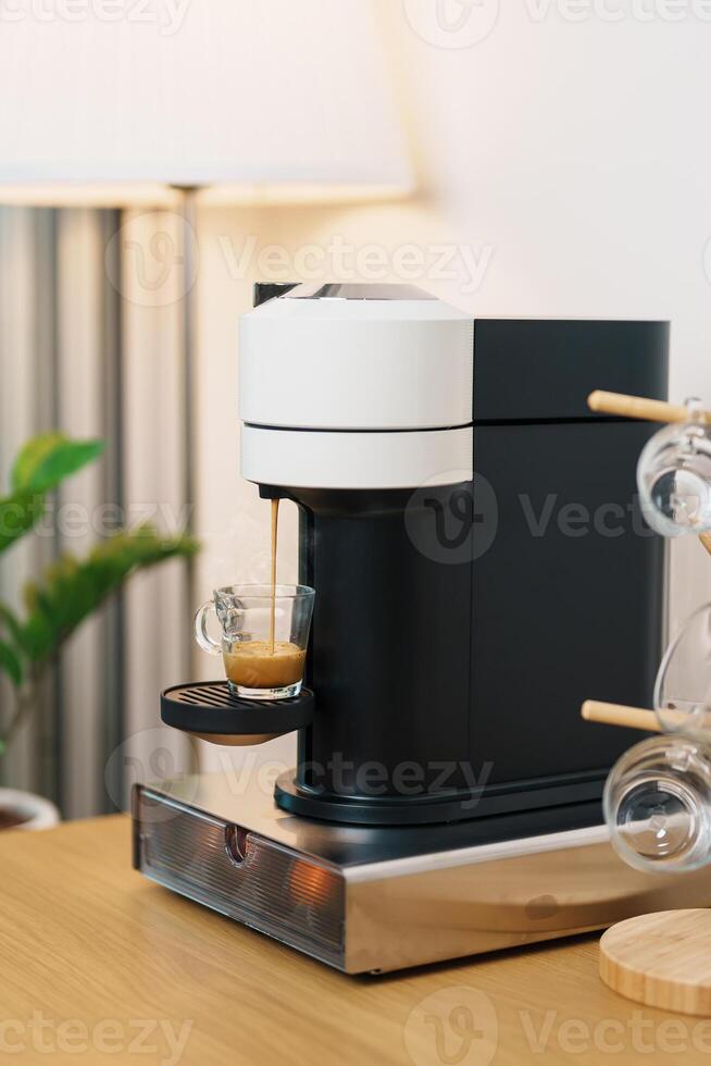Espresso cup with steam and froth during Coffee making Coffee by Coffee Maker Machine on wood table bar. Cafe shop, Daily beverage drink at Home, Apartment and Office concept photo
