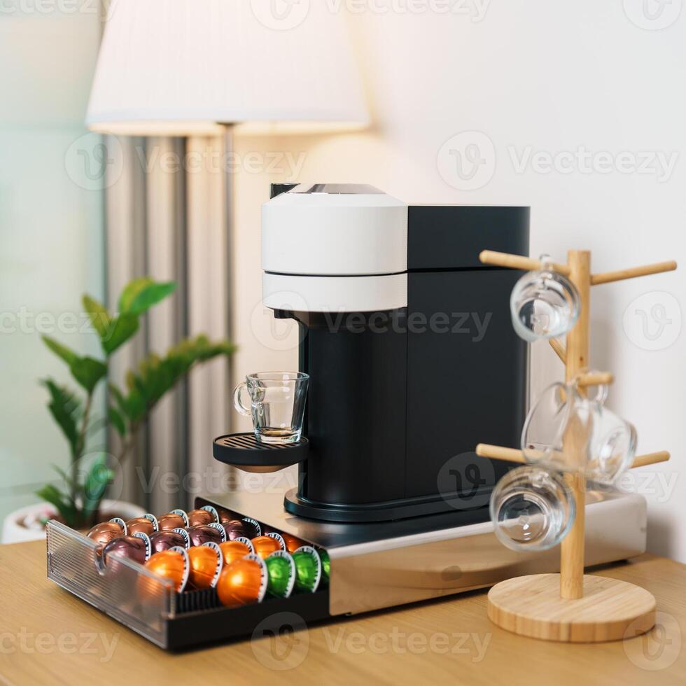 Espresso Coffee Maker Machine with Capsule of roasted coffee bean on wood table bar. Daily beverage drink at Home, Apartment and Office concept photo