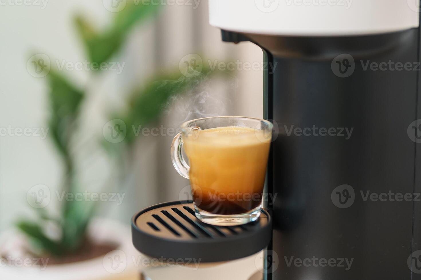 Espresso cup with steam and froth during Coffee making Coffee by Coffee Maker Machine on wood table bar. Cafe shop, Daily beverage drink at Home, Apartment and Office concept photo