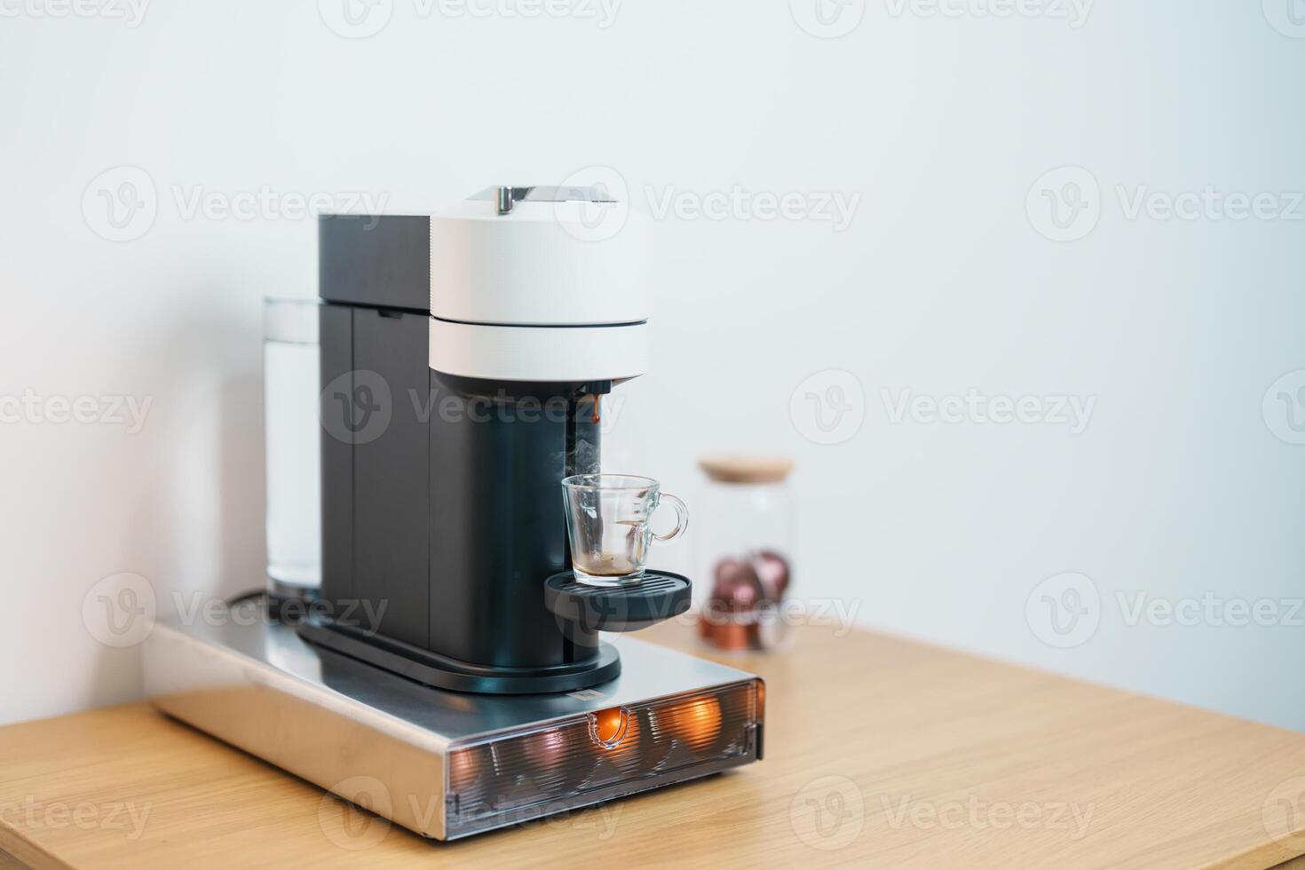 Espresso Coffee Maker Machine with Capsule of roasted coffee bean on wood table bar. Daily beverage drink at Home, Apartment and Office concept photo