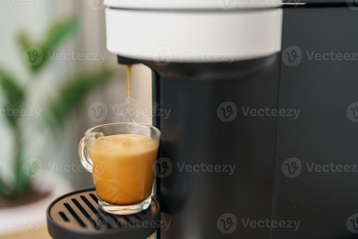 Espresso cup with steam and froth during Coffee making Coffee by Coffee Maker Machine on wood table bar. Cafe shop, Daily beverage drink at Home, Apartment and Office concept photo