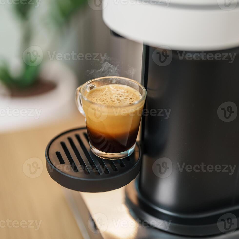 Espresso cup with steam and froth during Coffee making Coffee by Coffee Maker Machine on wood table bar. Cafe shop, Daily beverage drink at Home, Apartment and Office concept photo