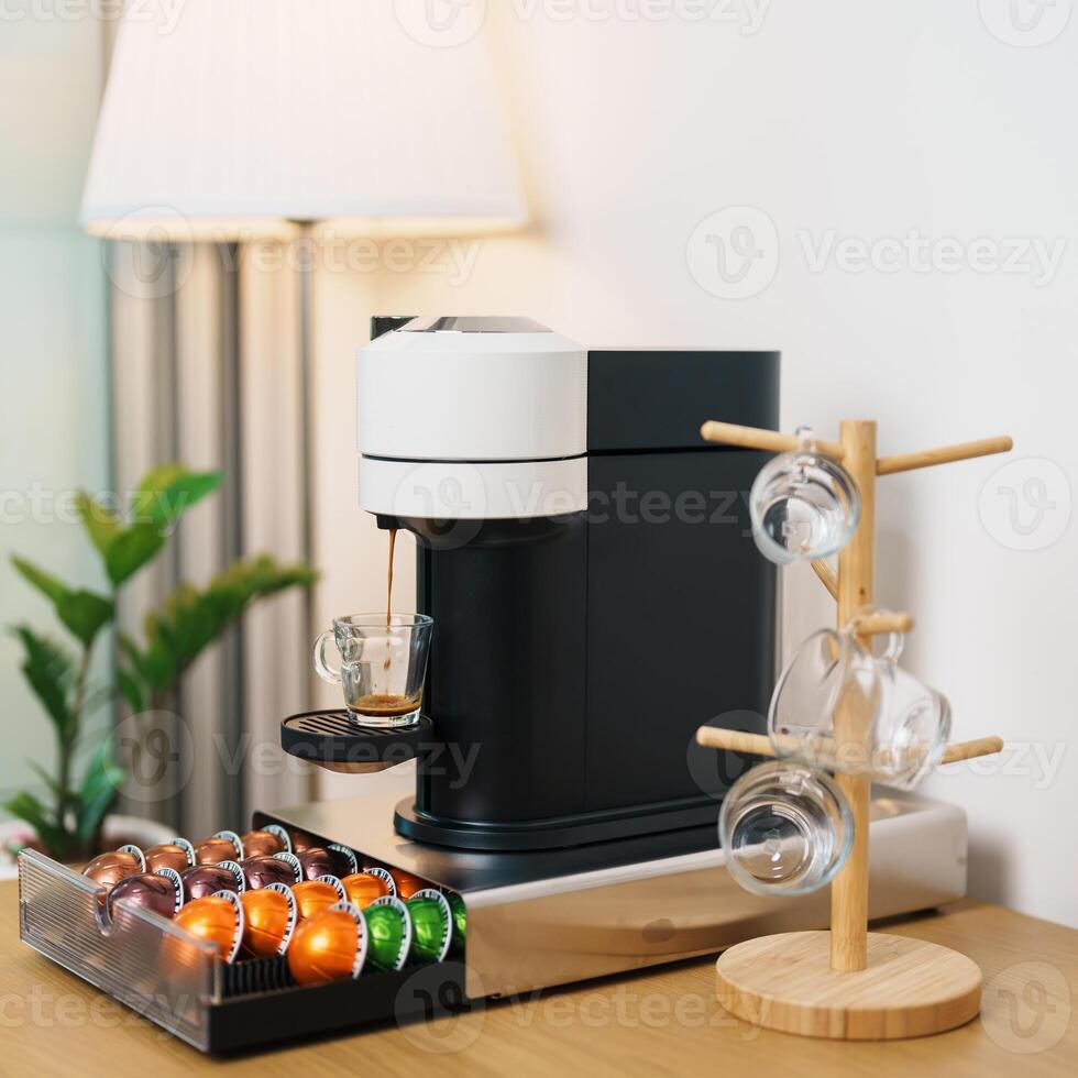Espresso Coffee Maker Machine with Capsule of roasted coffee bean on wood table bar. Daily beverage drink at Home, Apartment and Office concept photo