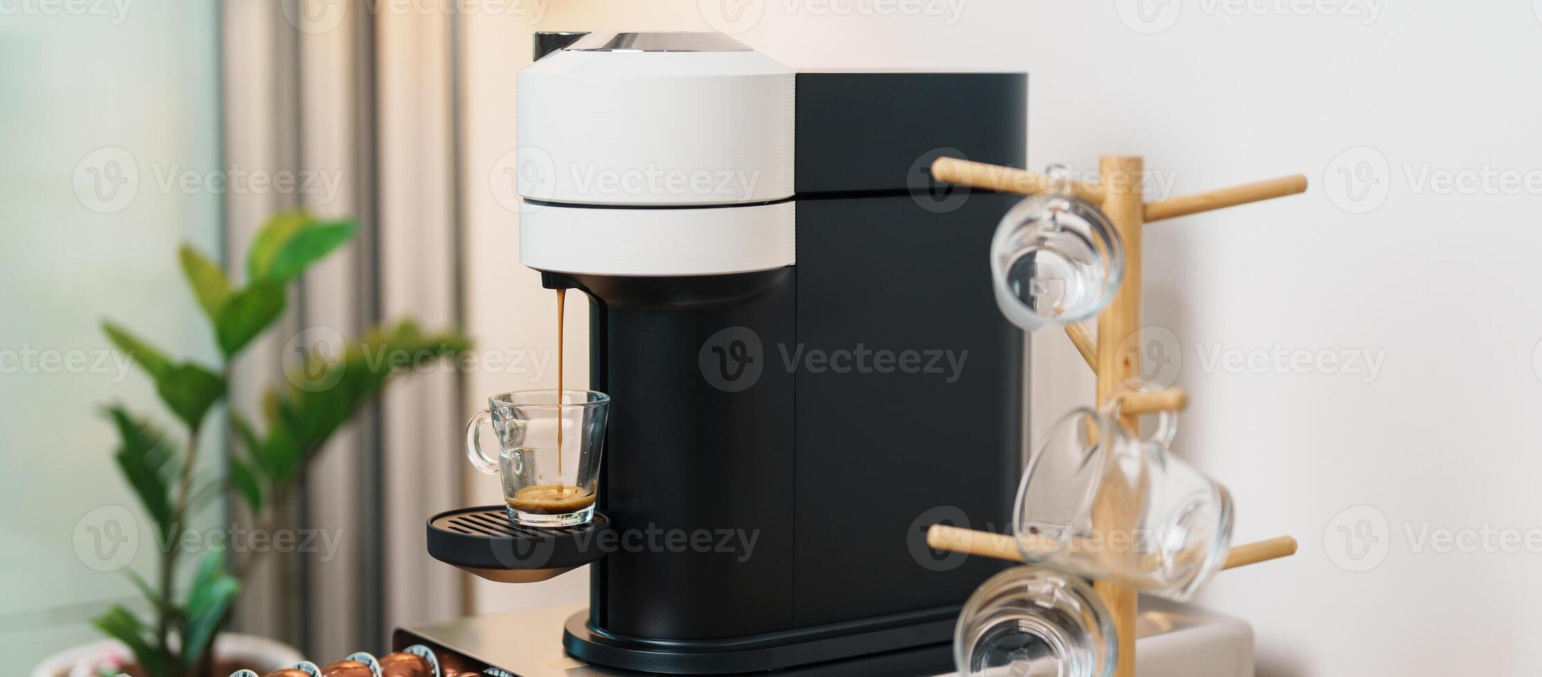 Espresso cup with steam and froth during Coffee making Coffee by Coffee Maker Machine on wood table bar. Cafe shop, Daily beverage drink at Home, Apartment and Office concept photo