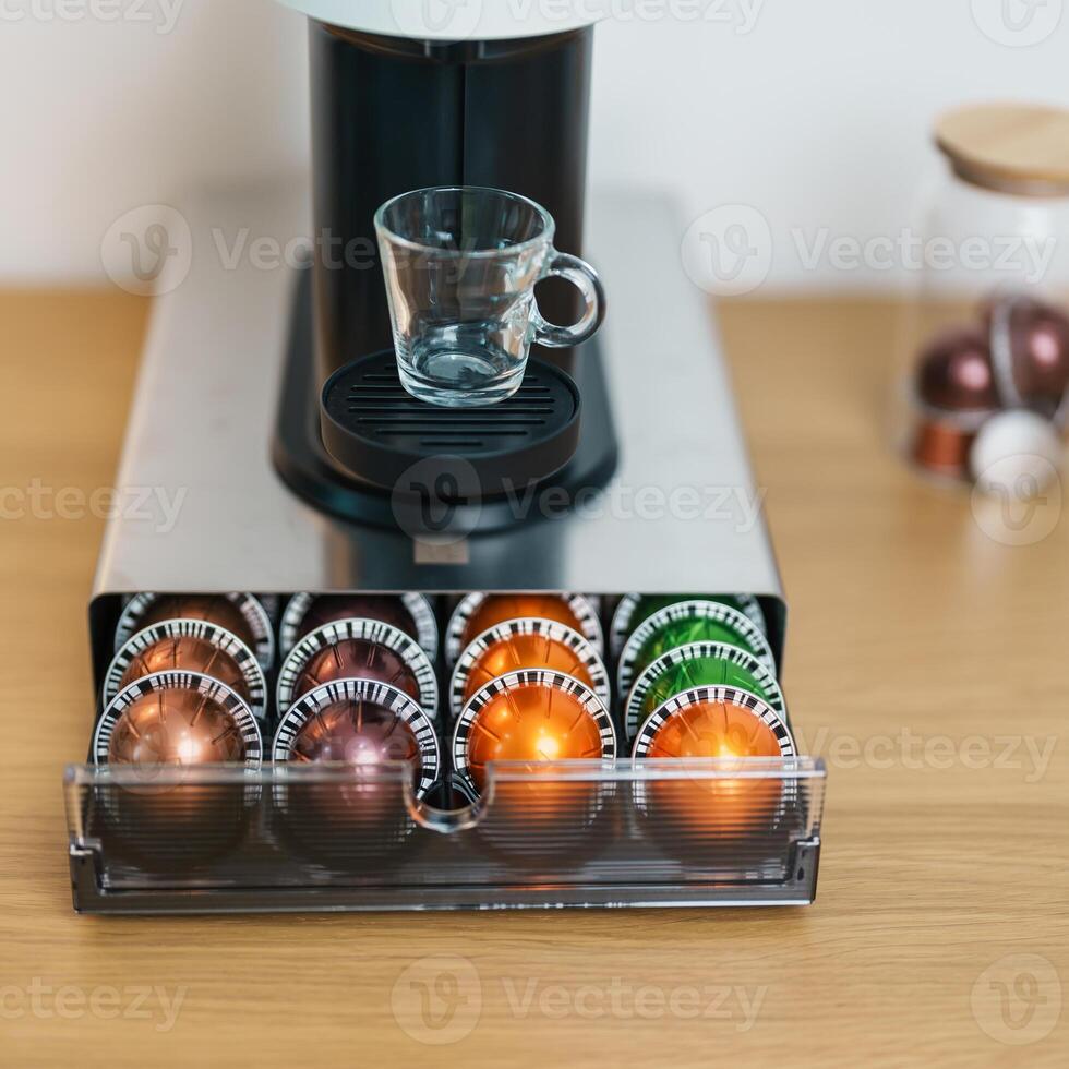 Espresso Coffee Maker Machine with Capsule of roasted coffee bean on wood table bar. Daily beverage drink at Home, Apartment and Office concept photo