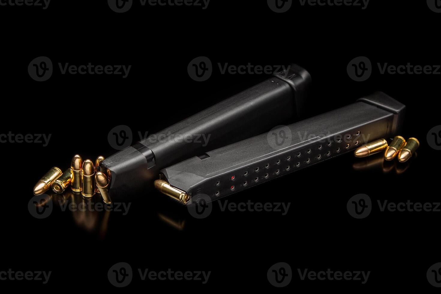 Pistol cartridges 9 mm on a smooth glossy surface with reflections. Ammunition for pistols and PCC carbines on a dark back. photo