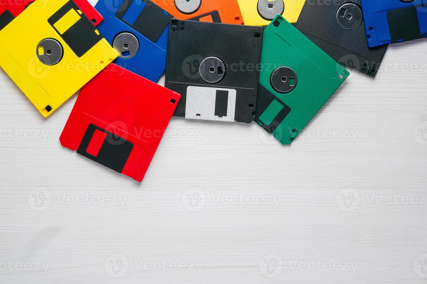 Vintage multi-colored floppy disk on white background photo