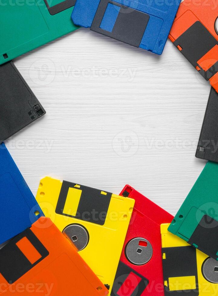 Vintage multi-colored floppy disk on white background photo