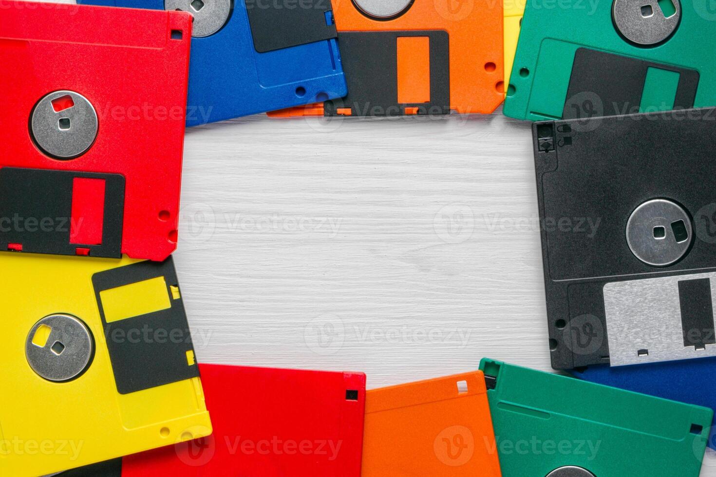 Vintage multi-colored floppy disk on white background photo