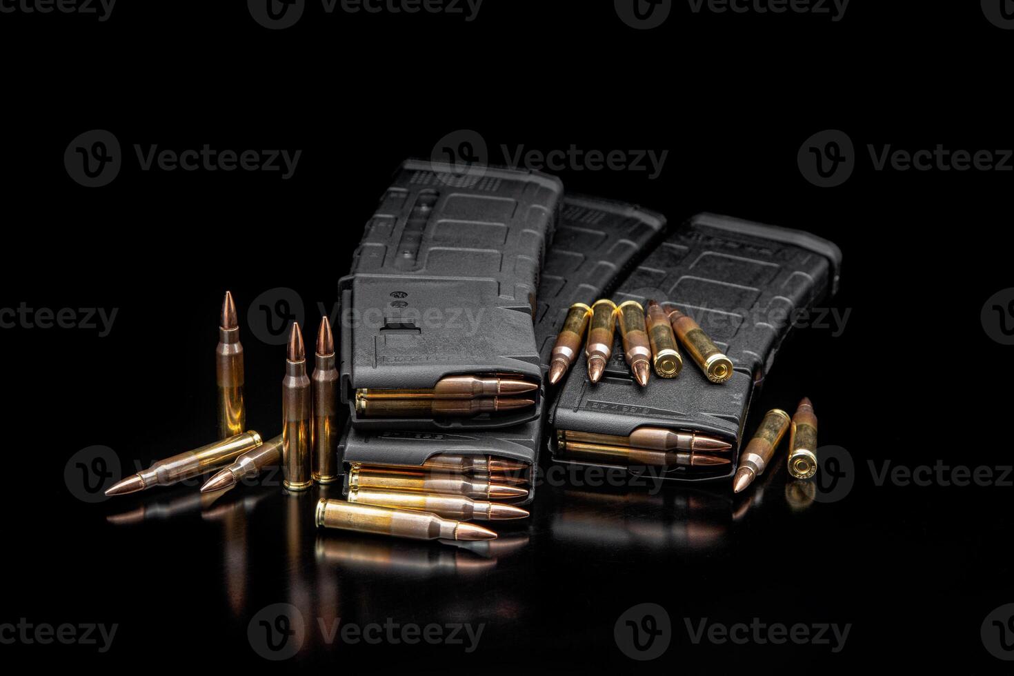 Bullet isolated on black background with reflexion. Rifle bullets close-up on black back. Cartridges for rifle and carbine on a black. photo
