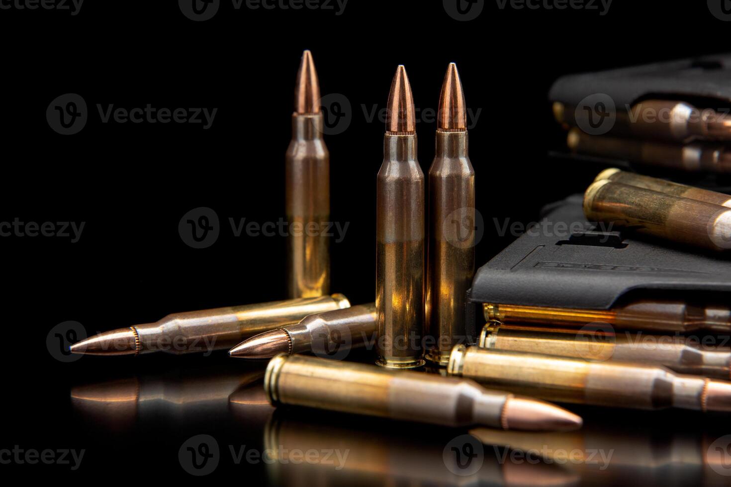 Bullet isolated on black background with reflexion. Rifle bullets close-up on black back. Cartridges for rifle and carbine on a black. photo