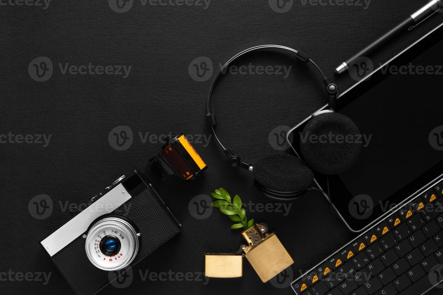 tablet with headphones near the keyboard photo