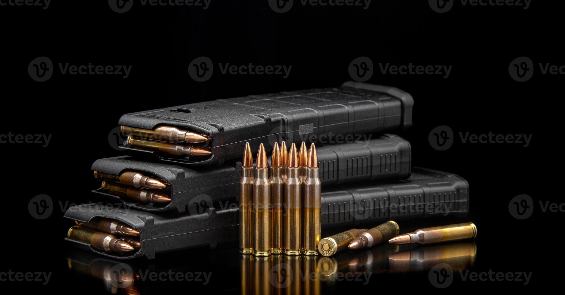 Bullet isolated on black background with reflexion. Rifle bullets close-up on black back. Cartridges for rifle and carbine on a black. photo