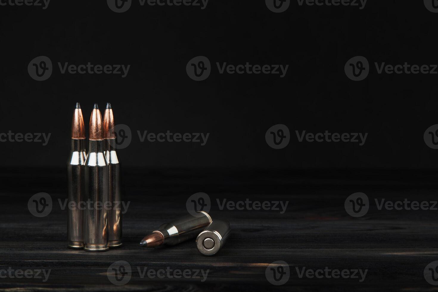 Cartridges on a wooden black background photo