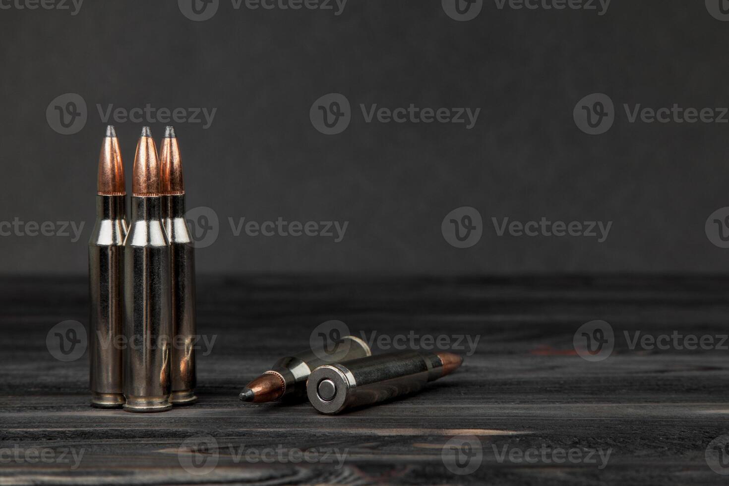 Cartridges on a wooden black background photo