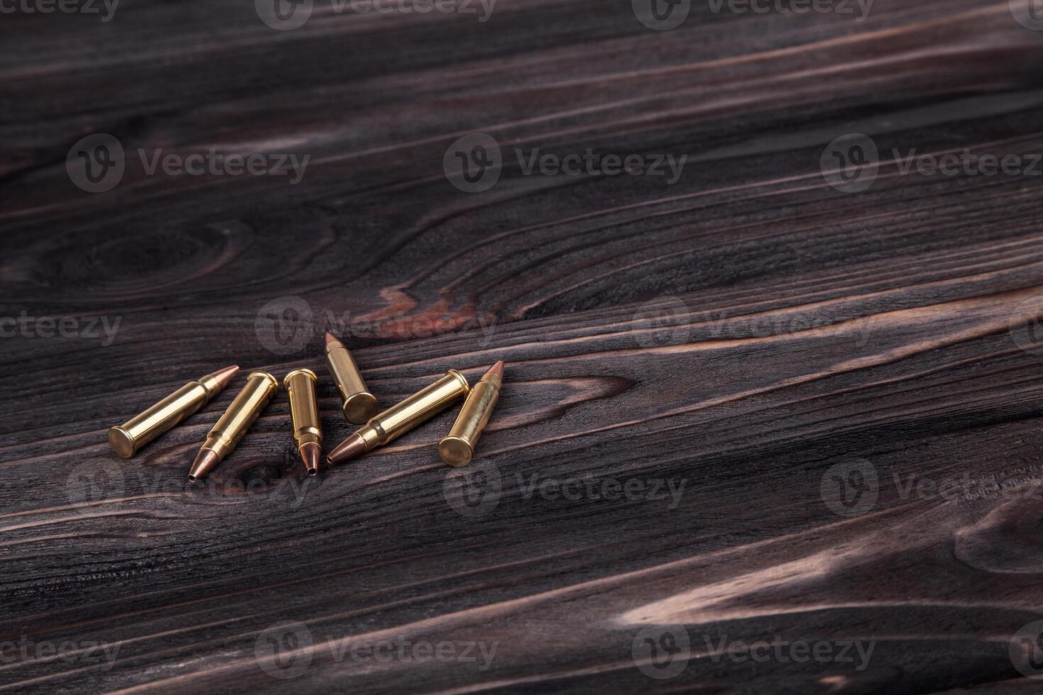 Cartridges on a wooden black background photo