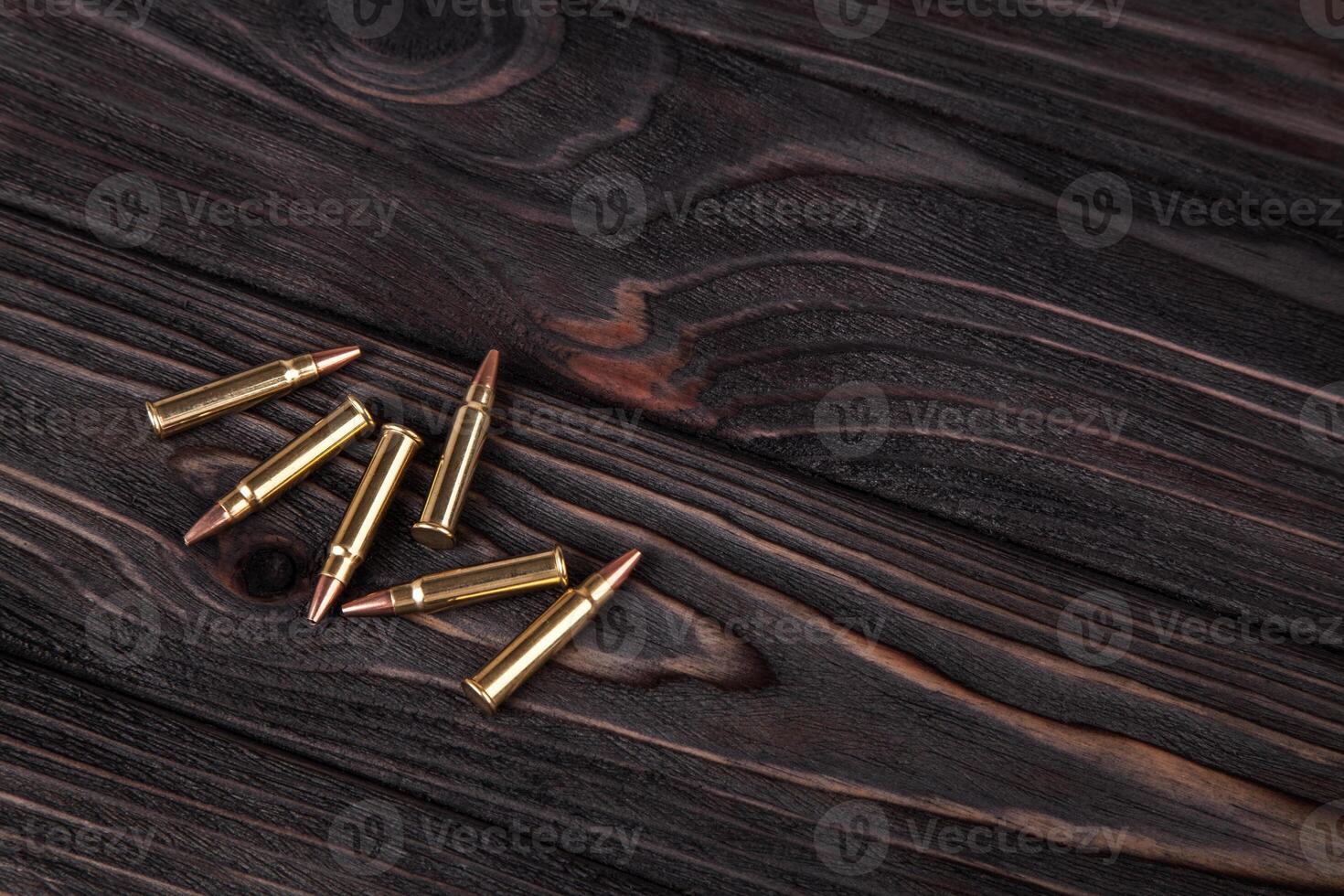 Cartridges on a wooden black background photo