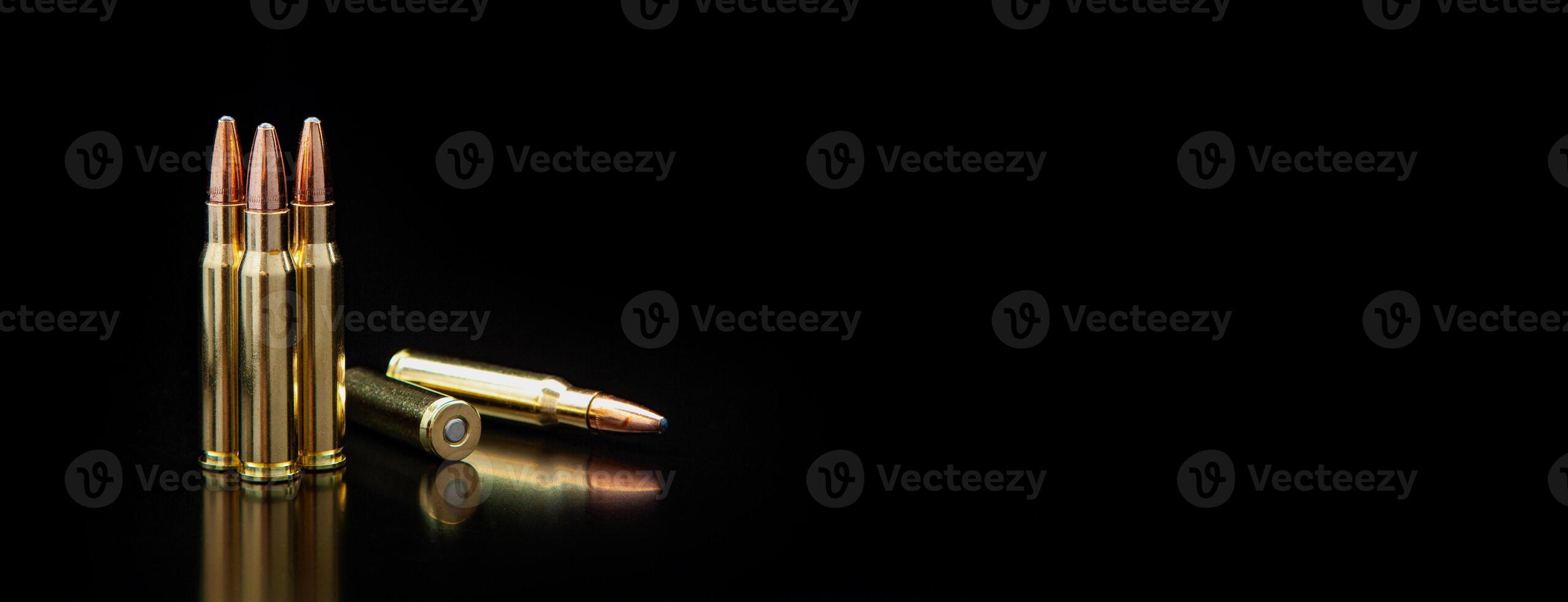 Bullet isolated on black background with reflexion. Rifle bullets close-up on black back. Cartridges for rifle and carbine on a black. photo
