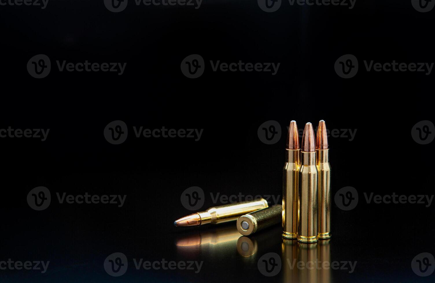 Bullet isolated on black background with reflexion. Rifle bullets close-up on black back. Cartridges for rifle and carbine on a black. photo