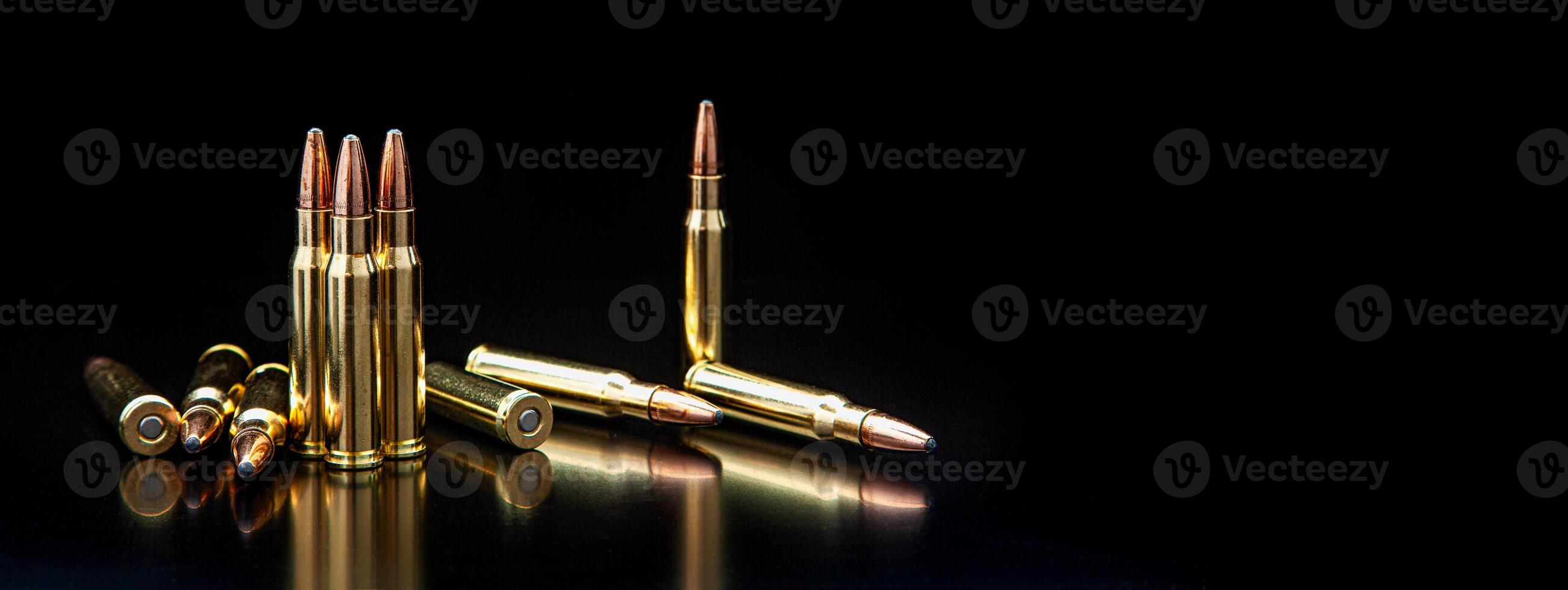 Bullet isolated on black background with reflexion. Rifle bullets close-up on black back. Cartridges for rifle and carbine on a black. photo