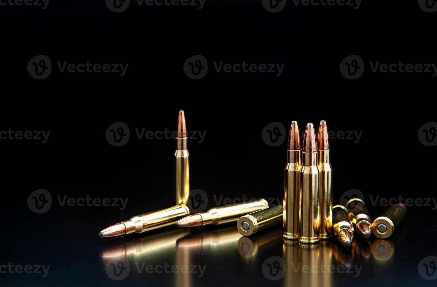 Bullet isolated on black background with reflexion. Rifle bullets close-up on black back. Cartridges for rifle and carbine on a black. photo