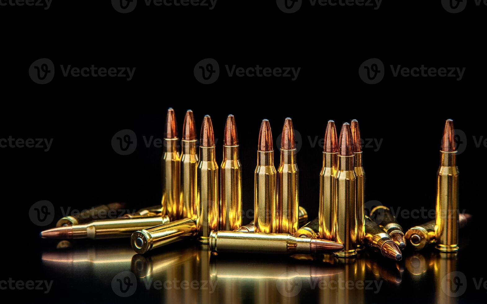 Bullet isolated on black background with reflexion. Rifle bullets close-up on black back. Cartridges for rifle and carbine on a black. photo