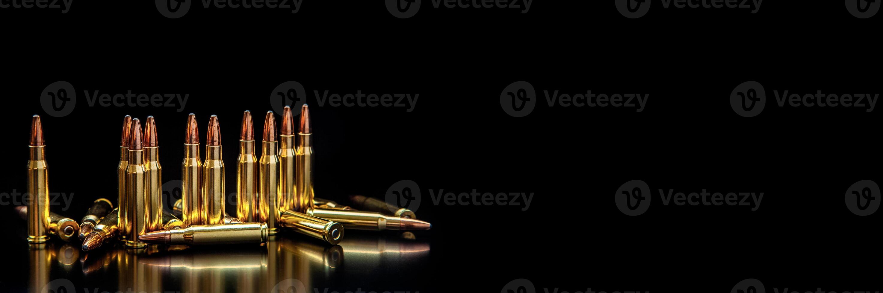Bullet isolated on black background with reflexion. Rifle bullets close-up on black back. Cartridges for rifle and carbine on a black. photo