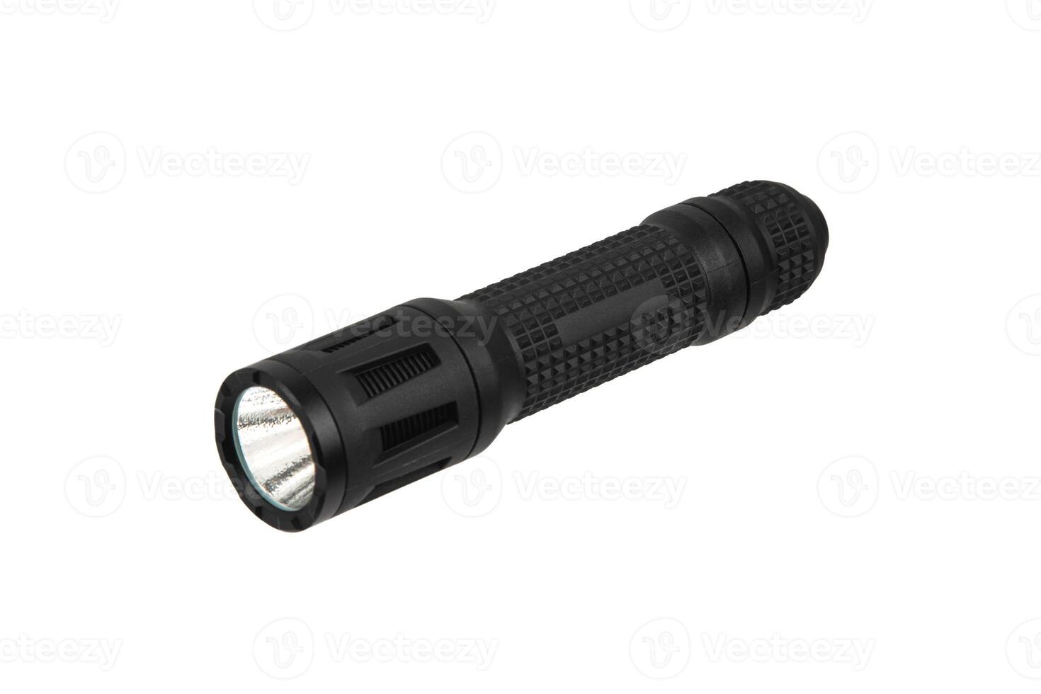 Black metal LED flashlight isolate on a white back. Pocket lamp for dark time of day or dark rooms. photo