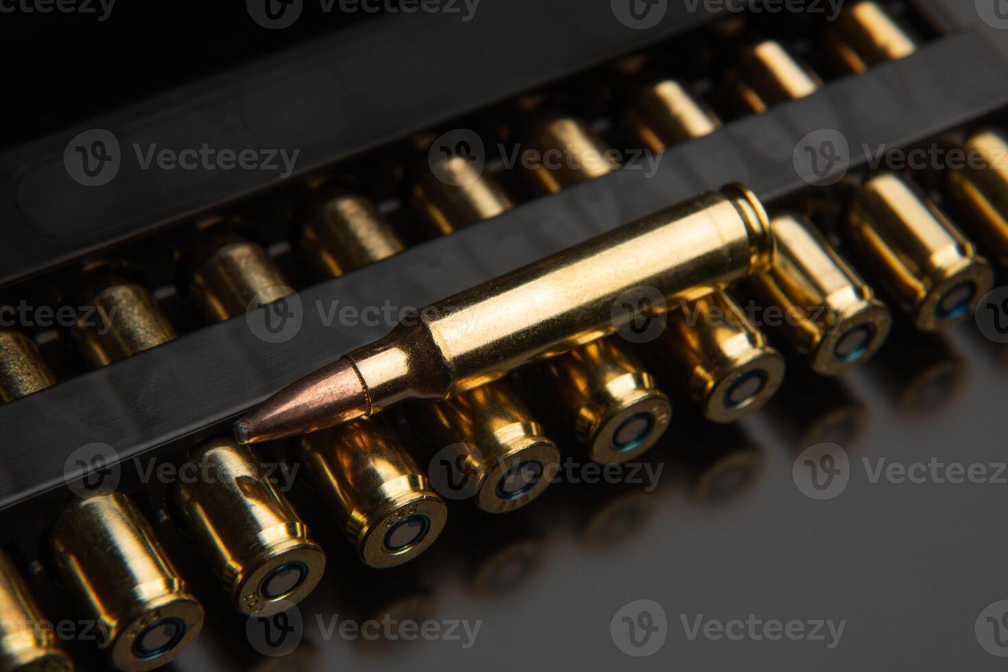 Bullet isolated on black background with reflexion. Rifle bullets close-up on black back. Cartridges for rifle and carbine on a black. photo