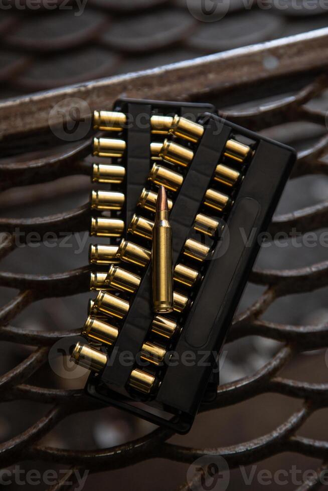 Cartridges for a carbine. Ammunition for rifled weapons. Dark lattice back photo