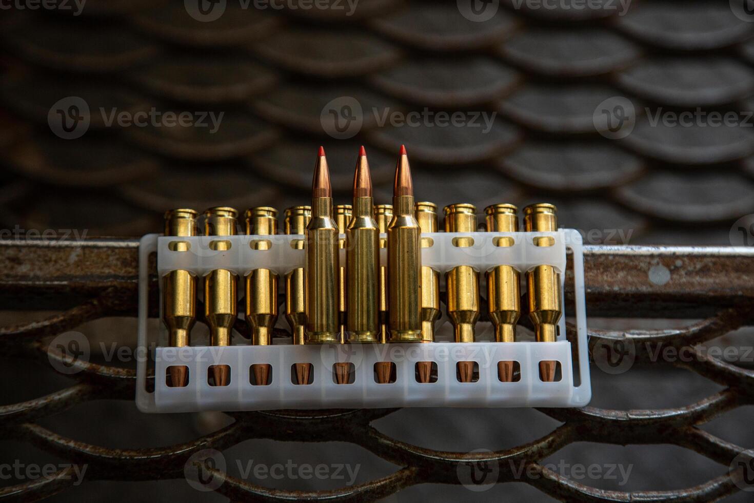 Cartridges for a carbine. Ammunition for rifled weapons. Dark lattice back photo