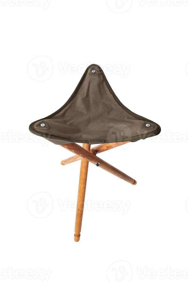 Folding wooden hunting stool tripod isolate on white background. Three-legged camping chair. photo