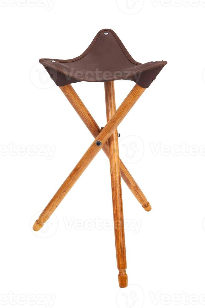 Folding wooden hunting stool tripod isolate on white background. Three-legged camping chair, Made of wood and leather. photo